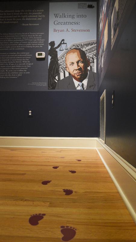 Footsteps lead visitors into the exhibit, Walking Into Greatness.